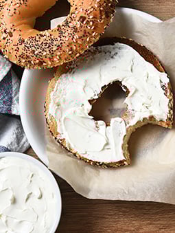A whole wheat flour everything bagel with cream cheese