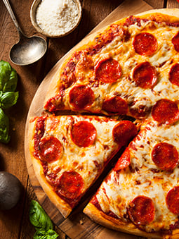 Pepperoni pizza with a slice cut