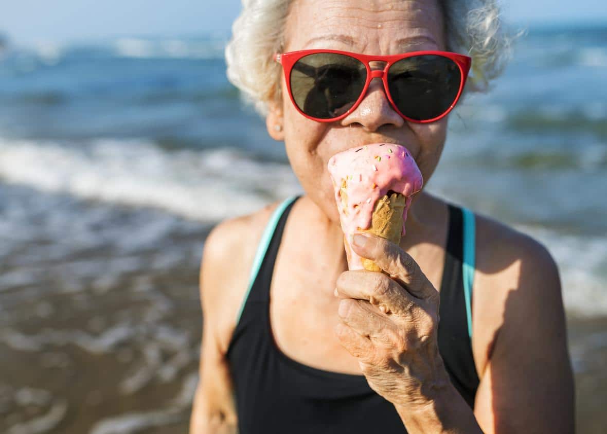 A woman enjoying ice cream on the beach