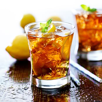Iced tea in a glass with ice and lemons