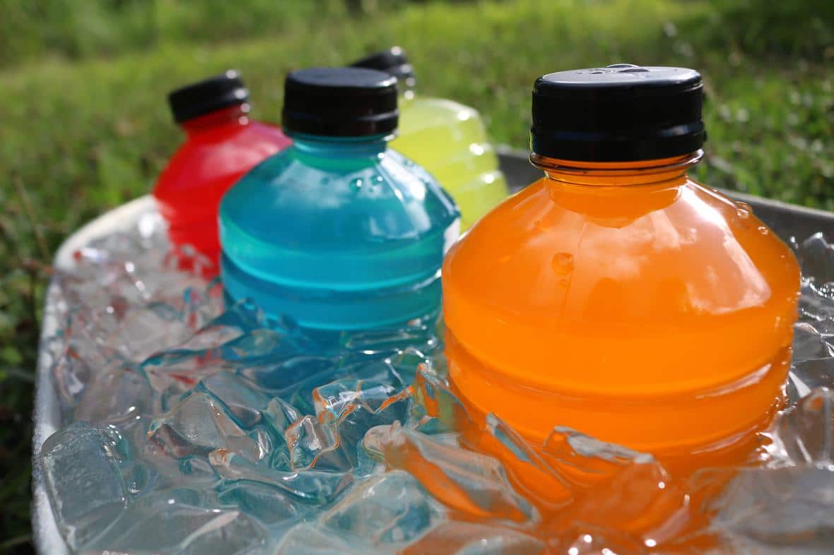 A variety of sports drinks sitting in ice