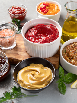 Dips, dressings, oils, and other condiments in a variety of bowls