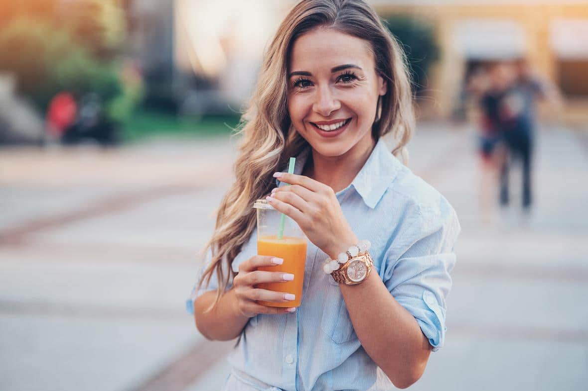 Woman drinking fresh juice outdoors