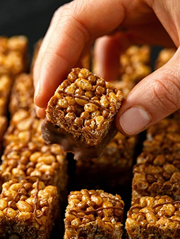 A hand holding a granola bar