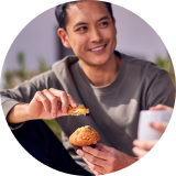 A person eating a muffin