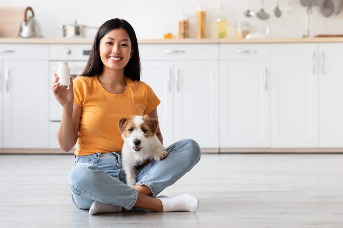 Woman with dog and pet supplements