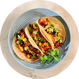 View from above three tacos with colorful vegetables and plant based protein on ceramic plate / Pogled odozgo na tri takosa sa šarenim povrćem i biljnim proteinima na keramičkom tanjiru