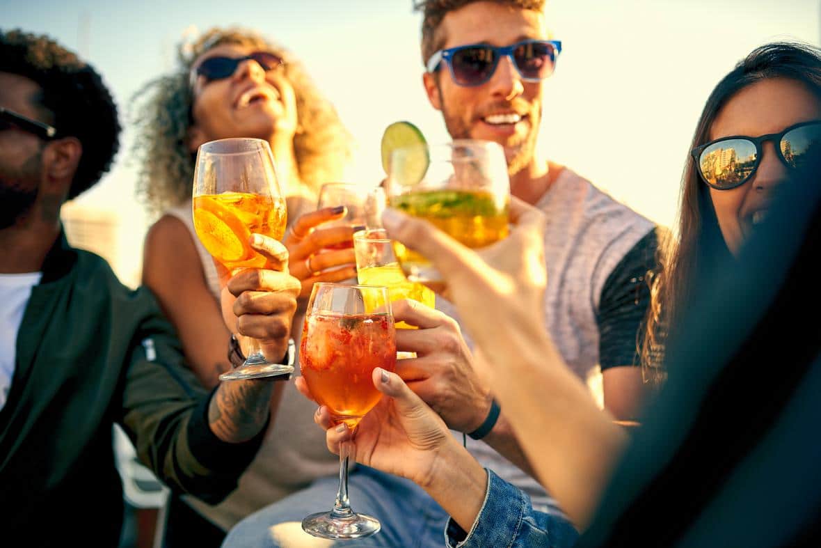 friends hanging out and having drinks together outdoors-GettyImages-998968848.jpg