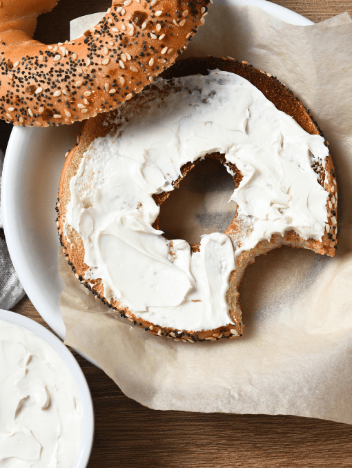 A whole wheat flour everything bagel with cream cheese