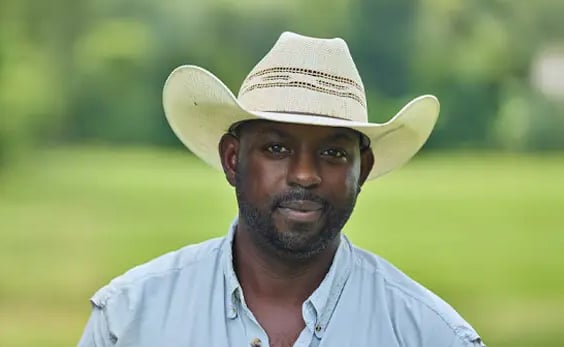 A farmer standing in a field.
