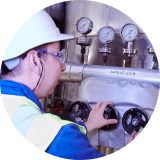 Factory worker looking at production of oils