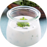 White ranch dressing in a small glass jar 