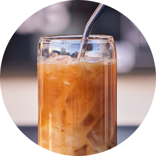 A glass of iced coffee with a straw