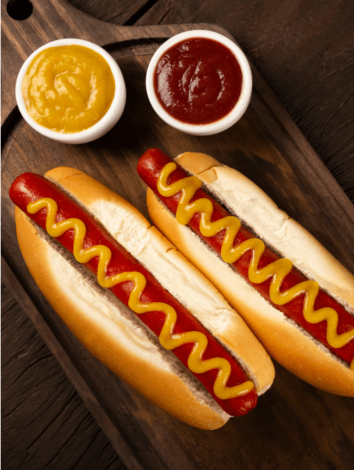 Two classic, red hot dogs in buns with ketchup and mustard