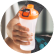 An athletic man in headphones listening to music and holding a pre-workout drink