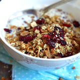 A bowl of granola with raisins 