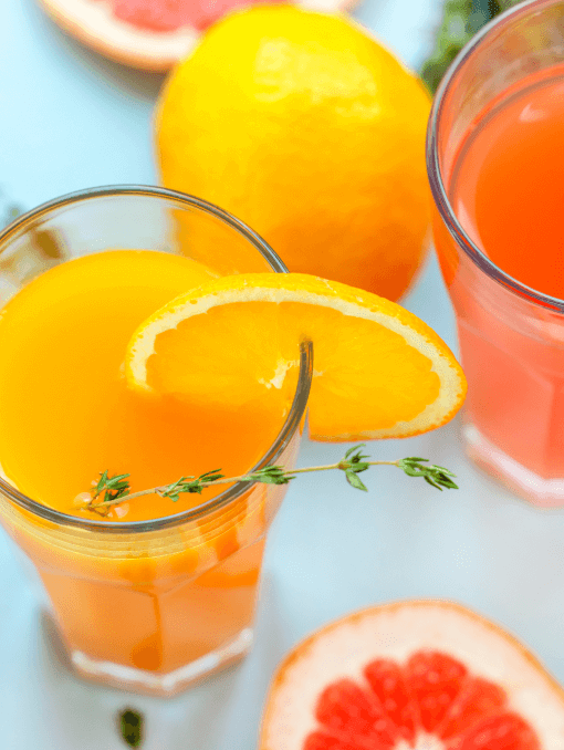 two glasses of orange juice or grapefruit juice