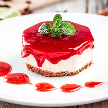 A miniature cheesecake with strawberry topping