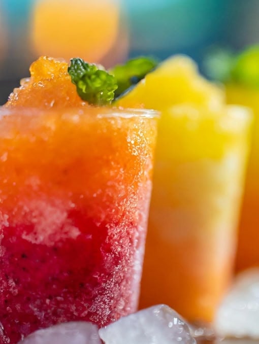 Bright orange, red, and yellow slushy drinks