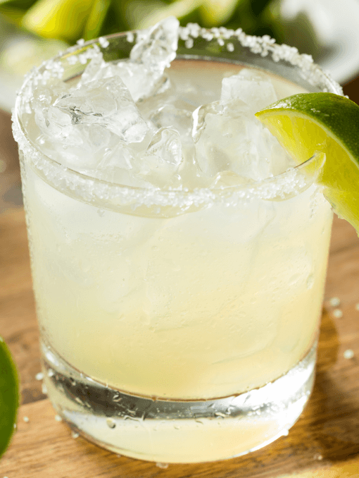 A margarita in a short glass, garnished with a lime
