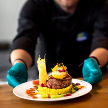 server placing dish of food on table