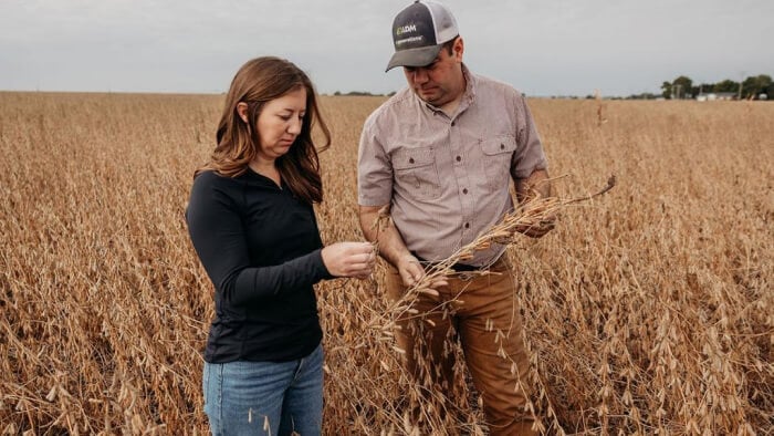 Two people standing in a wheat field
