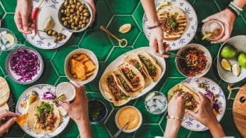 An aerial view of a bountiful table with pea- protein based meat alternatives.