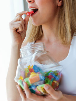 woman eating a jar of candy
