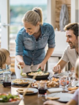 mom serving family dinner