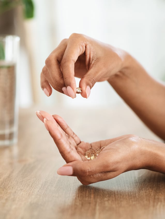 Woman taking dietary supplements for better health