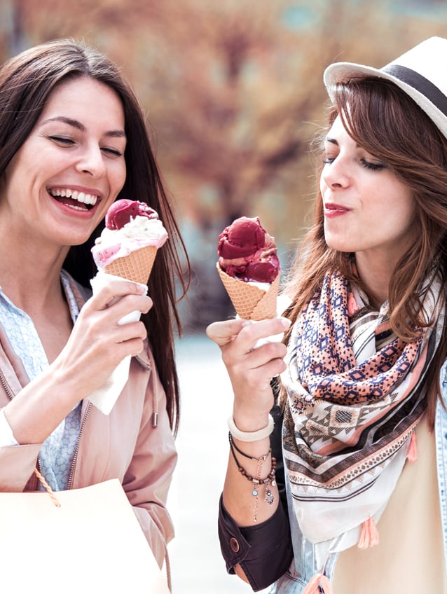 Two beautiful girls Women eating flavourful and colorful ice cream and shopping