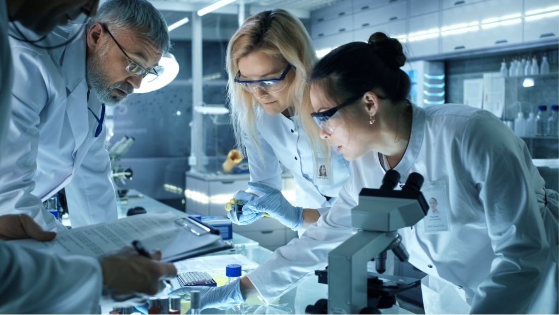 Scientist looking through a microscope