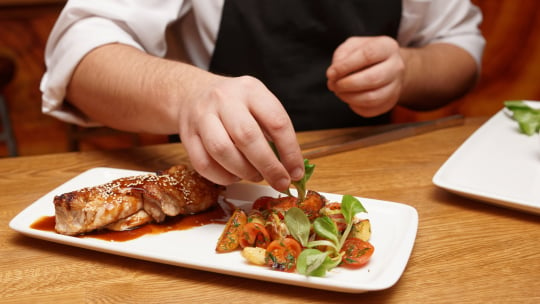 Chef dressing a plat