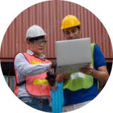 construction workers looking at laptop