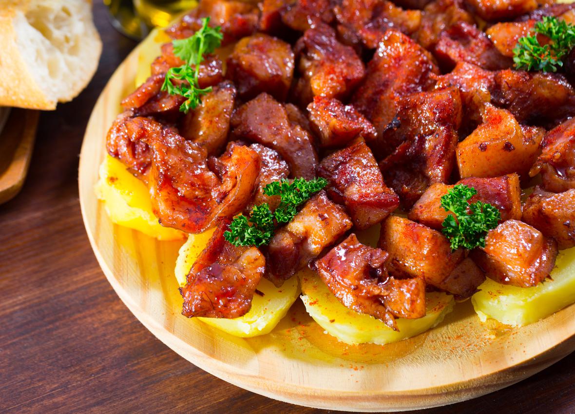 A savory stir-fry served on a wooden plate