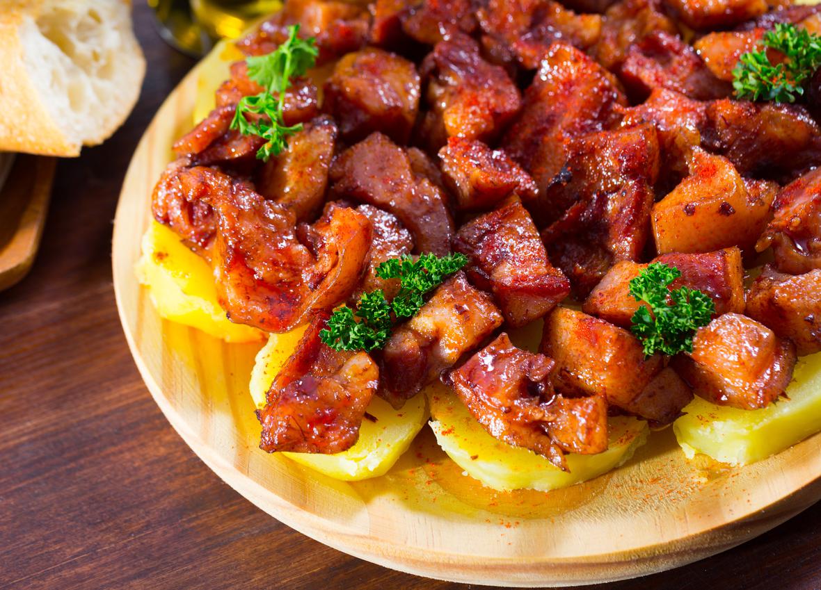 A savory stir-fry served on a wooden plate