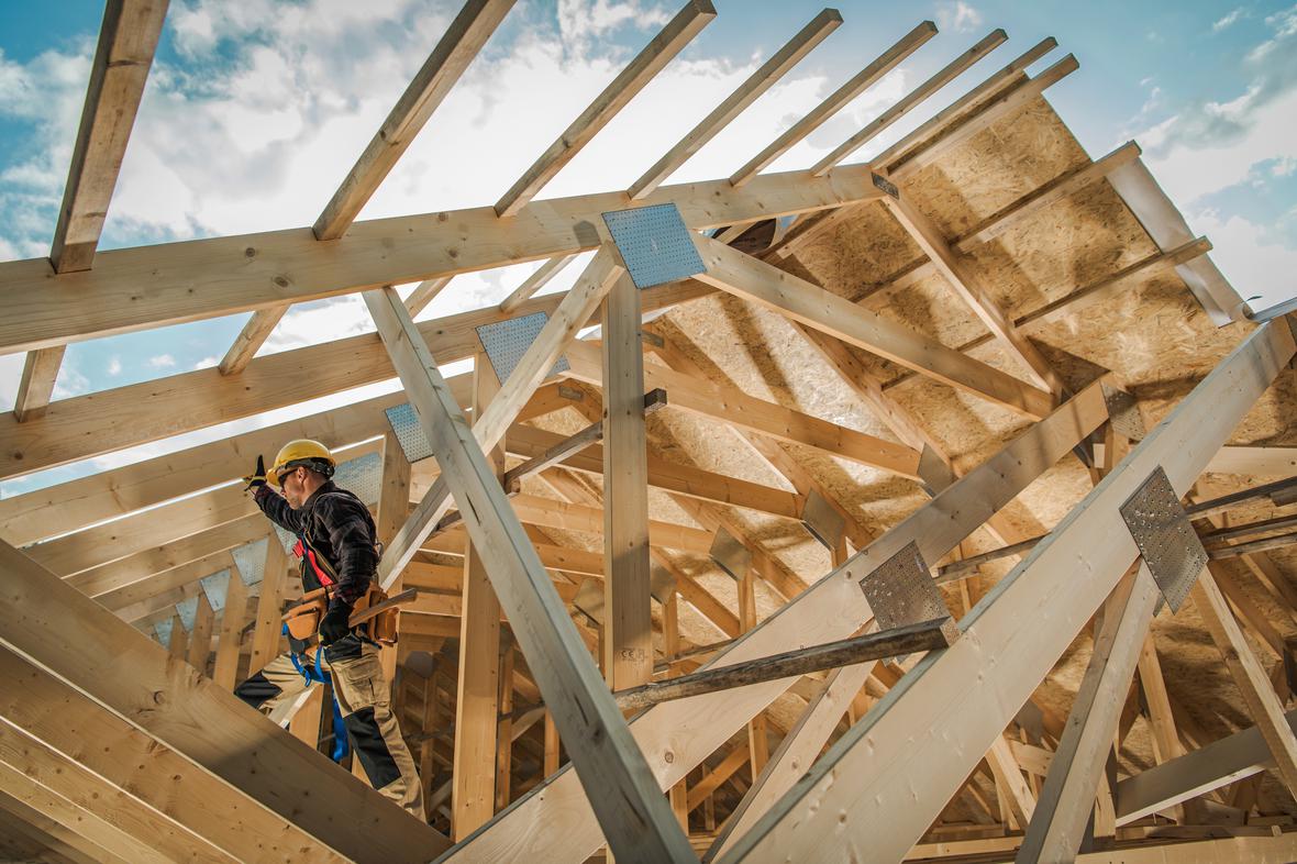 A construction worker putting together a building