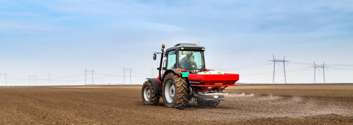 A farmer fertilizing a field