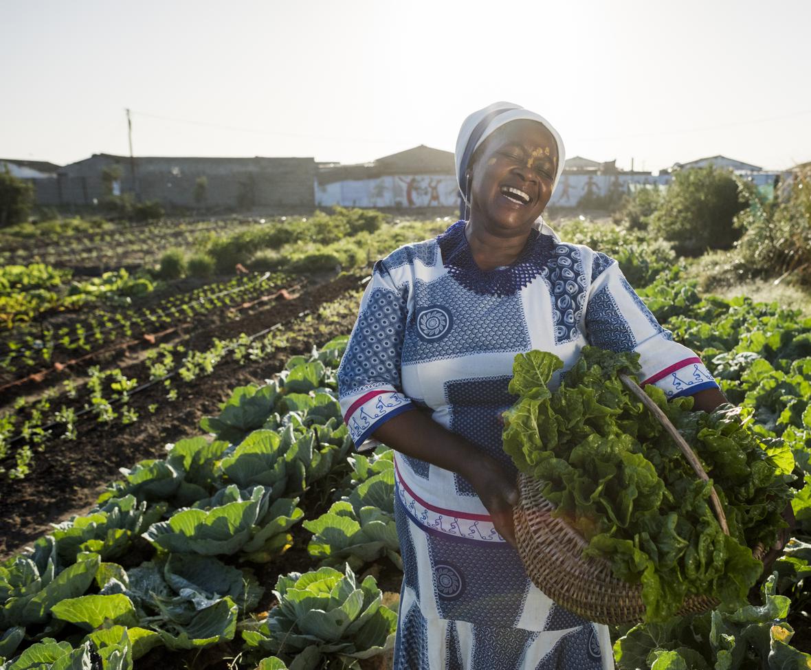 Woman smiling in a vegetable garden